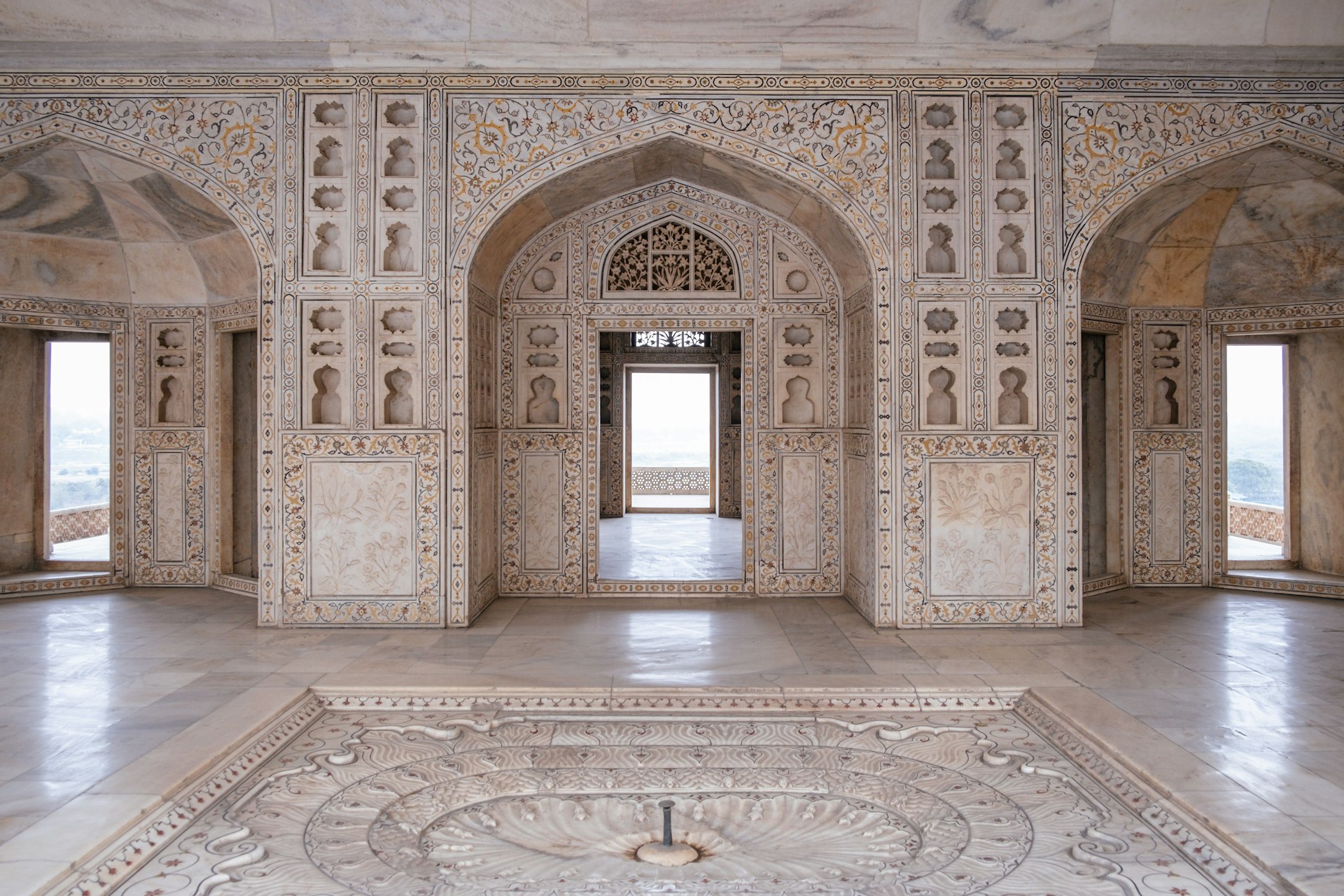 a large room with a marble floor and walls